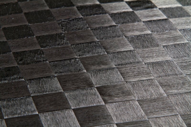 Woven carbon fiber texture close-up Close-up of a woven carbon fiber surface