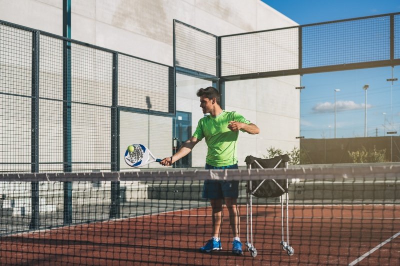 padel-practice-court-play man playing padel with racket on court