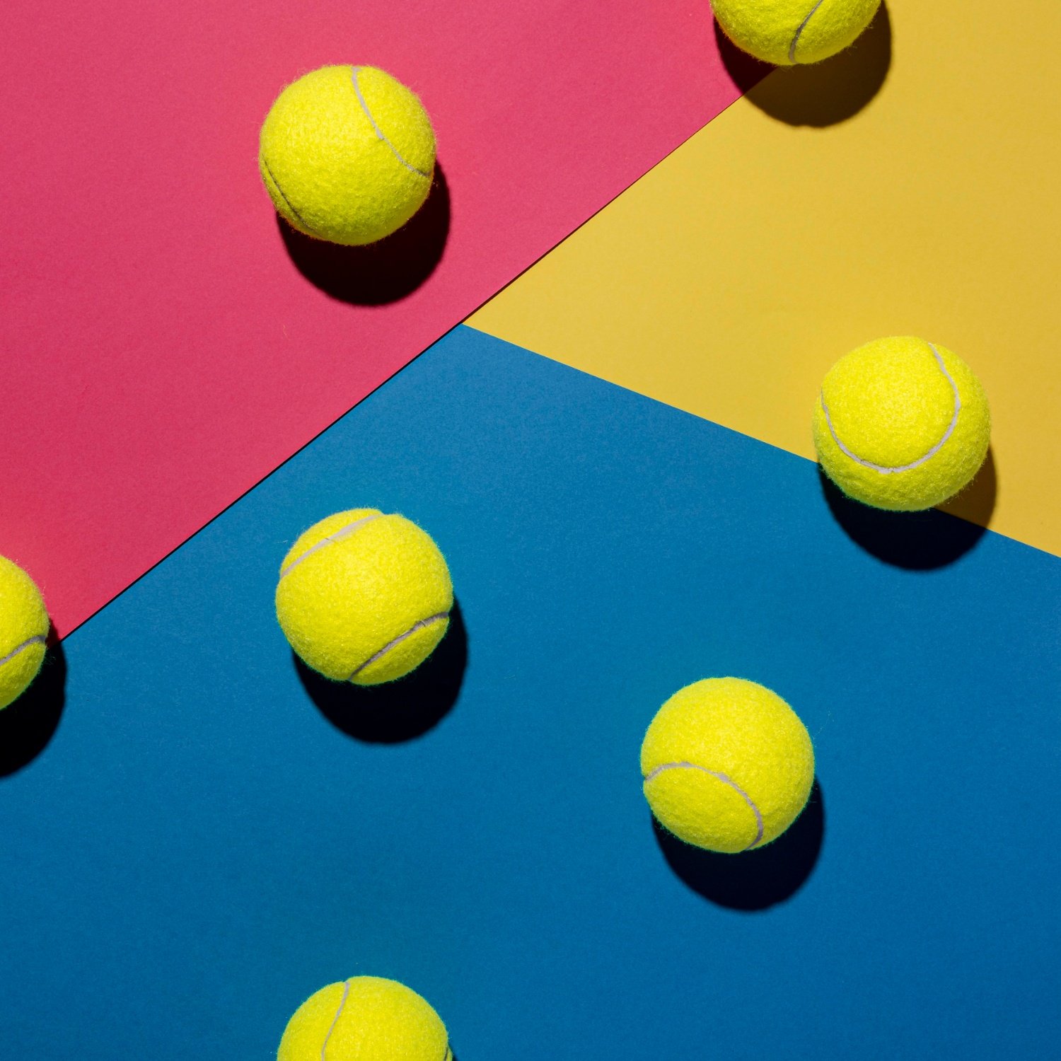 Colorful Padel Balls Arrangement Padel balls on pink, yellow, and blue background