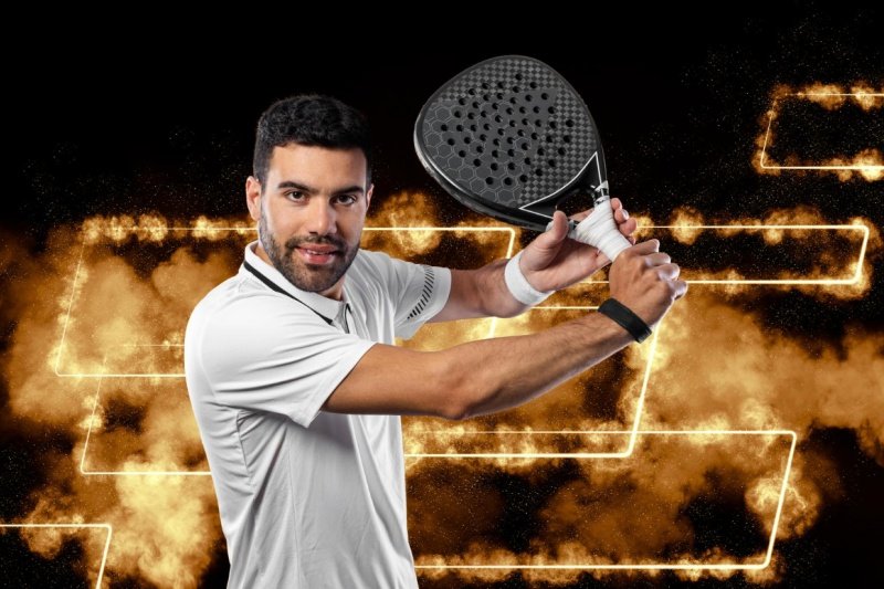 Smiling padel player in white holding black racket