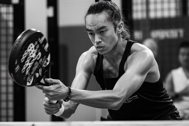 Determined padel athlete Intense padel player focusing on a shot in black and white