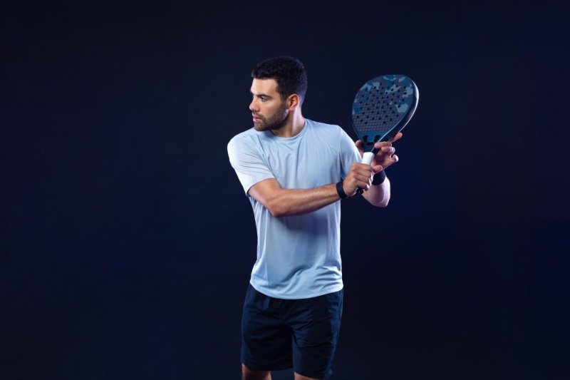 Focused padel athlete Padel player preparing for a backhand shot