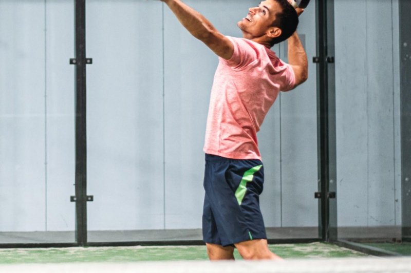 Focused padel athlete in action Padel player preparing to hit an overhead shot