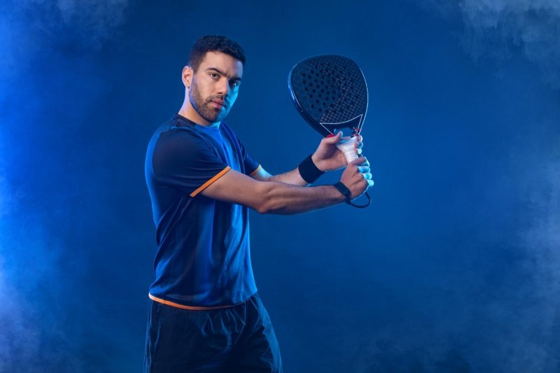 Focused padel athlete in action Padel player preparing for a backhand shot