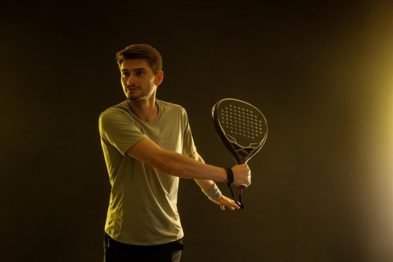 Padel backhand preparation Padel player preparing for a backhand shot, focused and ready
