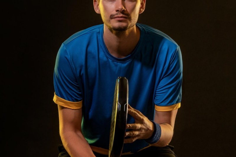 Padel player close-up Padel player holding racket, focused and determined expression