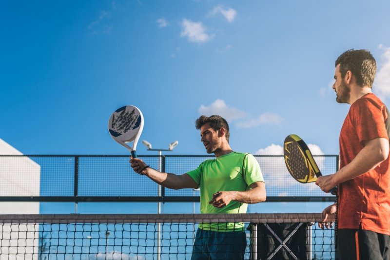 Padel players talking Two padel players discussing during a match on an outdoor court