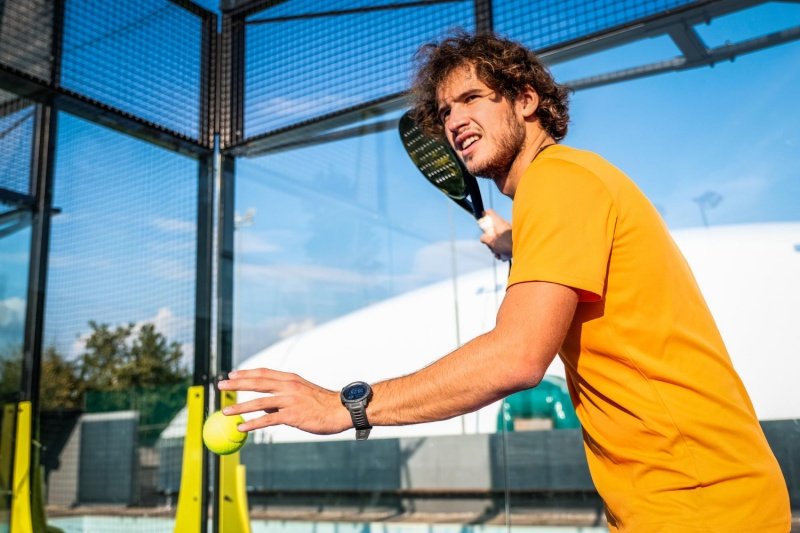 Padel serve preparation Padel player preparing to serve on outdoor court