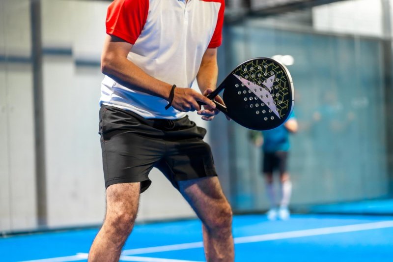 Padel Ready Stance padel player in ready position holding racket during indoor match
