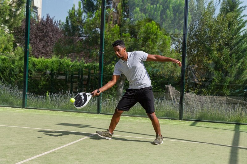 Outdoor Padel Forehand Male padel player executes forehand shot on outdoor court