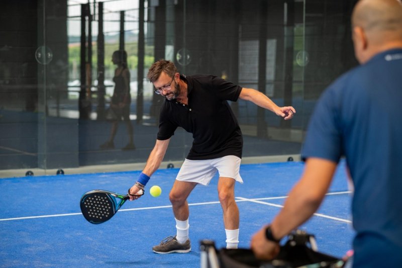 Padel Forehand Practice Man executing forehand shot during indoor padel practice