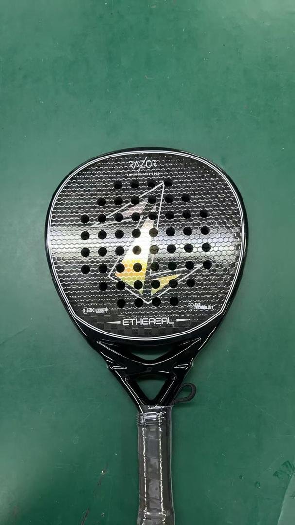 carbon padel racket black carbon fiber padel racket with honeycomb texture and central logo on green surface
