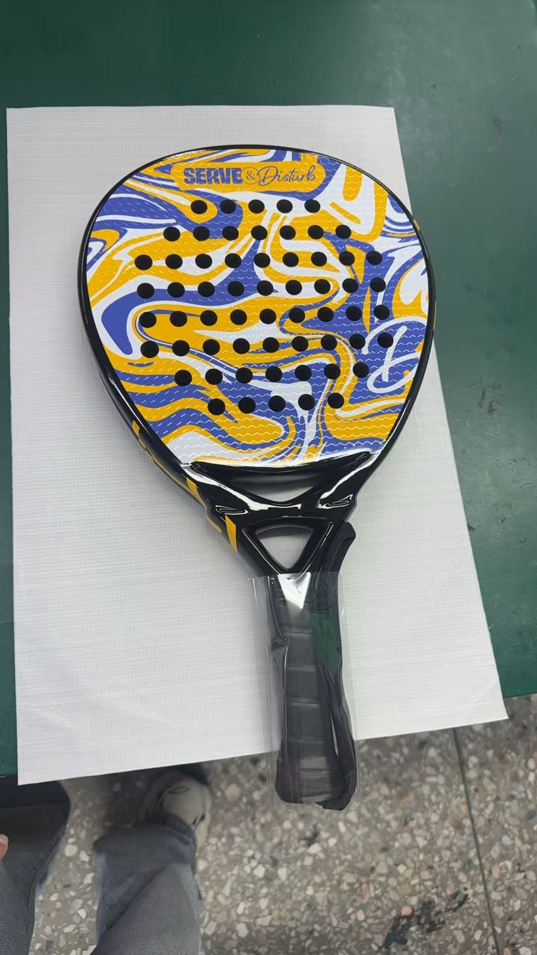 Serve and Disturb colorful padel racket - bold yellow blue white abstract design